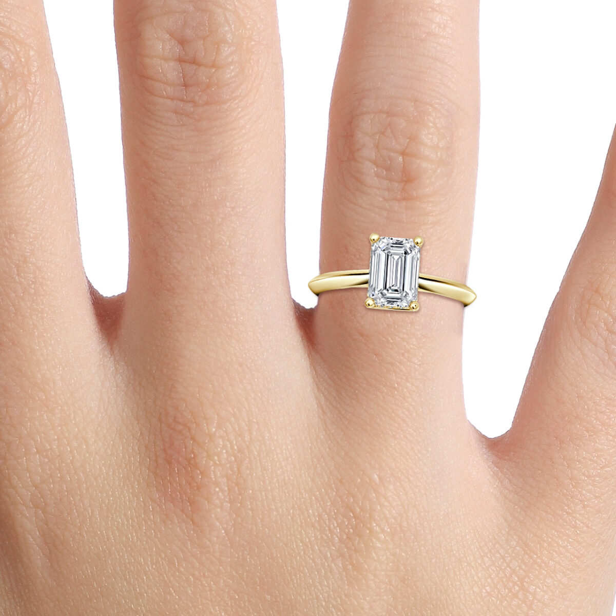 On Hand View - Classic Emerald cut lab grown diamond solitaire ring in plain yellow gold band.